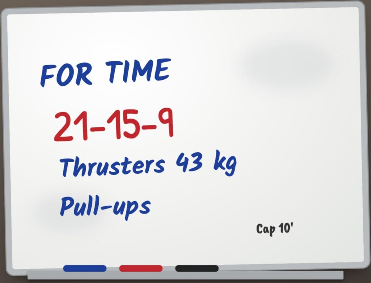 A gym whiteboard with a handwritten WOD: For Time, 21-15-9, thrusters 43 kg, pull-ups, cap 10 minutes